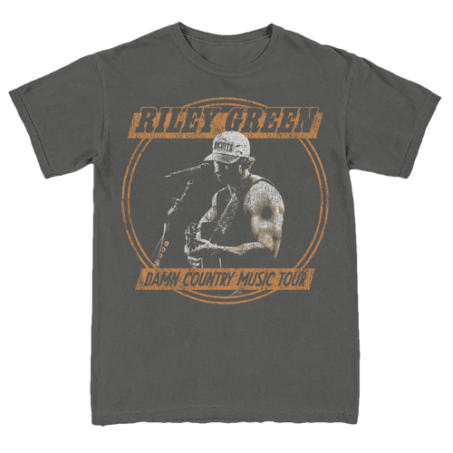 Gray t-shirt with a graphic of a person playing guitar and text 'Riley Green Damn Country Music Tour' on a white background.
